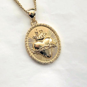 men's and women's sacred heart pendant necklace in 14k and 18k gold, with an oval shape
